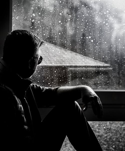 Silhouette of a person in a meditation pose against a mint-colored background.